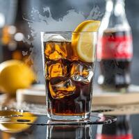 A glass of cola with ice and lemon slices photo