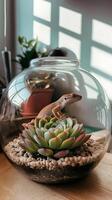 A geckole is sitting in a glass bowl on a table photo