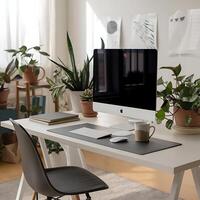 A desk with a computer, mouse, and a plant photo