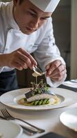 A chef is preparing food on a plate photo