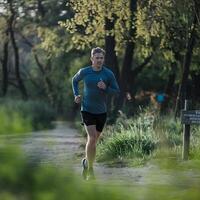 A man is running in the woods photo
