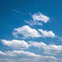 A blue sky with white clouds and a few clouds photo