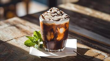 An iced coffee with whipped cream and mint photo