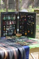 A Beautiful Array of Colorful Handmade Jewelry and Belts Displayed Outdoors for All photo
