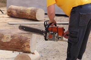 Chainsaw in Action Masterfully Cutting Logs with Precision and Exceptional Skill photo