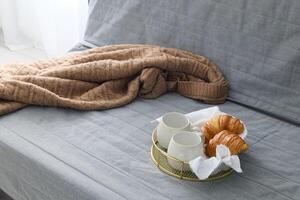 An Inviting and Cozy Breakfast Setting Featuring Delightful Croissants and Warm Tea photo