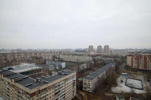 Urban Landscape Featuring Overcast Sky Alongside Various Residential Buildings and Structures photo