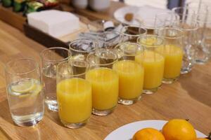 A Beautifully Arranged Refreshing Display of Orange Juice and Water for All Occasions photo