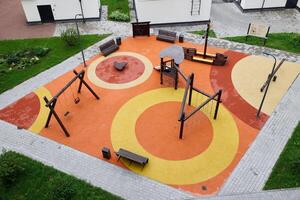 A modern playground featuring a vibrant rubber surface, exciting equipment for play photo