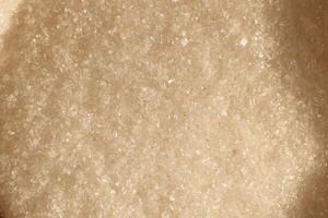 Closeup of granulated brown sugar, highlighting its fine texture and unique qualities photo