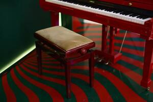 Beautifully Elegant Red Piano Paired with a Matching Bench in Unique and Artistic Interior Setup photo