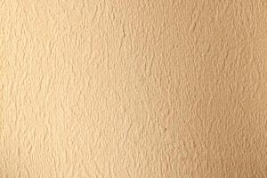 Textured Beige Wall Surface Ideal for Various Background Use in Design and Decor Projects photo