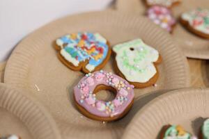 Vibrantly Colorful Decorated Cookies Displayed on Festive Paper Plates for Everyone to Enjoy photo