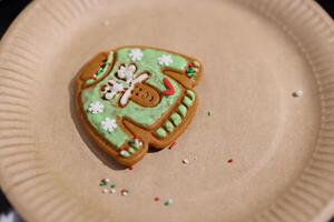 Festive Gingerbread Sweater Cookie Decorated with Colorful Icing and Lots of Sprinkles photo