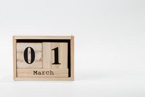 Wooden calendar March 01 on a white background photo