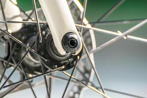 partial view of the front wheel of a road racing bicycle, spokes and braking system background for cycling concept photo