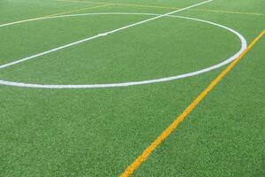 Detail of the center of an artificial grass 7-a-side football field. photo