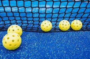 pickleball balls near the net on a pickleball court, racket sports background photo