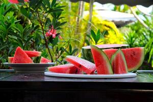 Slices of ripe watermelon on wooden table close up photo