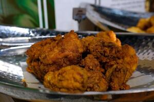 Fried chicken on a white plate with tomato sauce and chili sauce, top view food table photo