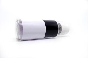 A white and black bottle with a black stripe photo
