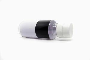 A white and black bottle with a white cap photo