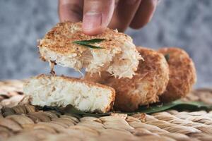 Indonesian Traditional Coconut Cake called Sagon on Banana Leaf with Rustic Background Setting photo