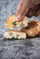Indonesian Traditional Coconut Cake called Sagon on Banana Leaf with Rustic Background Setting photo