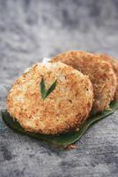Indonesian Traditional Coconut Cake called Sagon on Banana Leaf with Rustic Background Setting photo