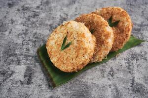 Indonesian Traditional Coconut Cake called Sagon on Banana Leaf with Rustic Background Setting photo