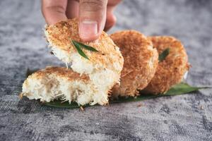 Indonesian Traditional Coconut Cake called Sagon on Banana Leaf with Rustic Background Setting photo