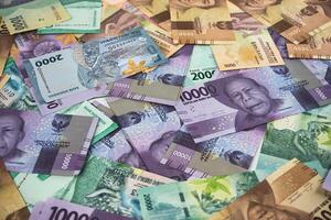 Various Colorful Indonesian Rupiah Banknotes Displayed in a Scattered Arrangement photo