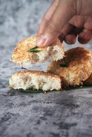 Indonesian Traditional Coconut Cake called Sagon on Banana Leaf with Rustic Background Setting photo