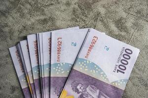 Indonesian Rupiah Fan Arrangement on Textured Surface photo