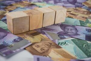 Wooden Blocks Over Banknotes Depicting Financial Planning and Investment Concepts photo