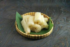 Freshly Cooked Cassava Served in a Basket on a Banana Leaf photo