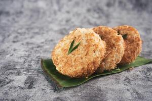 Indonesian Traditional Coconut Cake called Sagon on Banana Leaf with Rustic Background Setting photo
