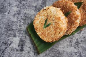 Indonesian Traditional Coconut Cake called Sagon on Banana Leaf with Rustic Background Setting photo