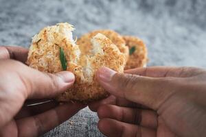 Indonesian Traditional Coconut Cake called Sagon on Banana Leaf with Rustic Background Setting photo