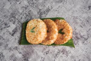 Indonesian Traditional Coconut Cake called Sagon on Banana Leaf with Rustic Background Setting photo