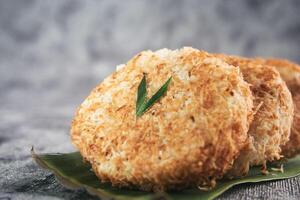 Indonesian Traditional Coconut Cake called Sagon on Banana Leaf with Rustic Background Setting photo