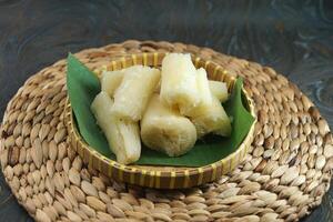 Freshly Cooked Cassava Served in a Traditional Basket on a Rustic Surface photo