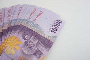 Indonesian Rupiah Banknotes Arranged in Ascending Rows on White Background photo