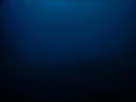 Dark blue degradation of view from deep sea, abstract background photo