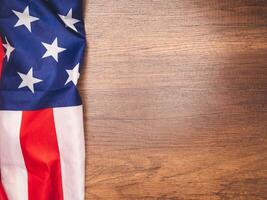 Top view of the American flag on a wooden table with copy space for text photo