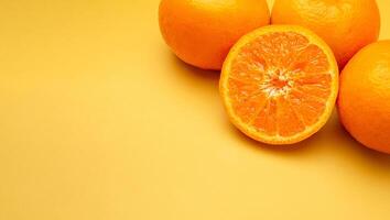 Top view of fresh oranges over a yellow background photo
