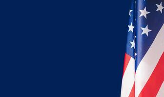 Close-up of the American flag is on the right side on a blue background photo