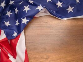 Top view of the American flag on a wooden table with copy space for text photo