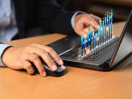 Business person analyzing financial report on a virtual screen while sitting at a desk in the office photo