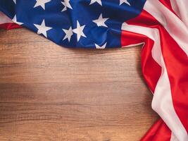 Top view of the American flag on a wooden tabler with copy space for text photo